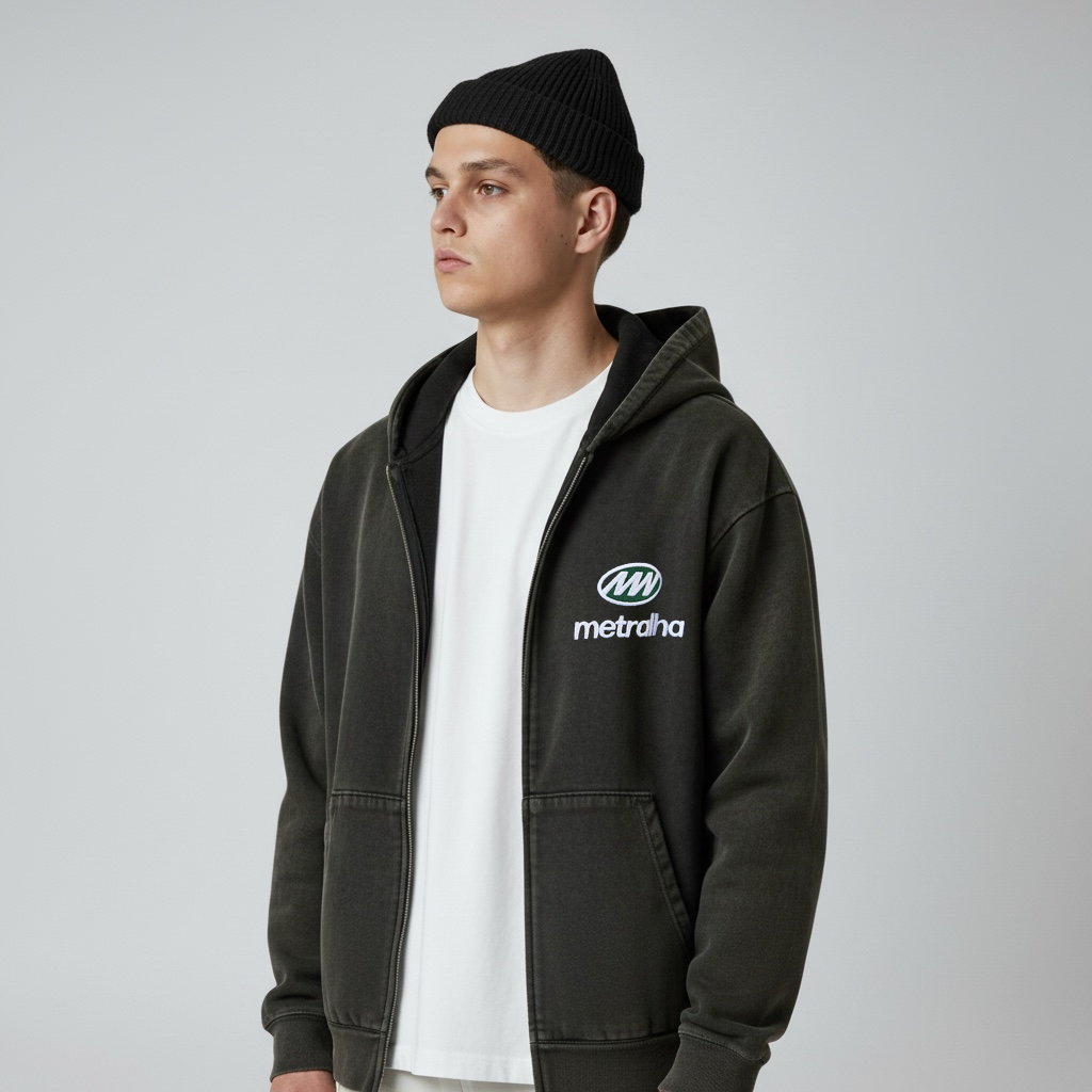 Person wearing a black hoodie with a logo and Black beanie on a gray background