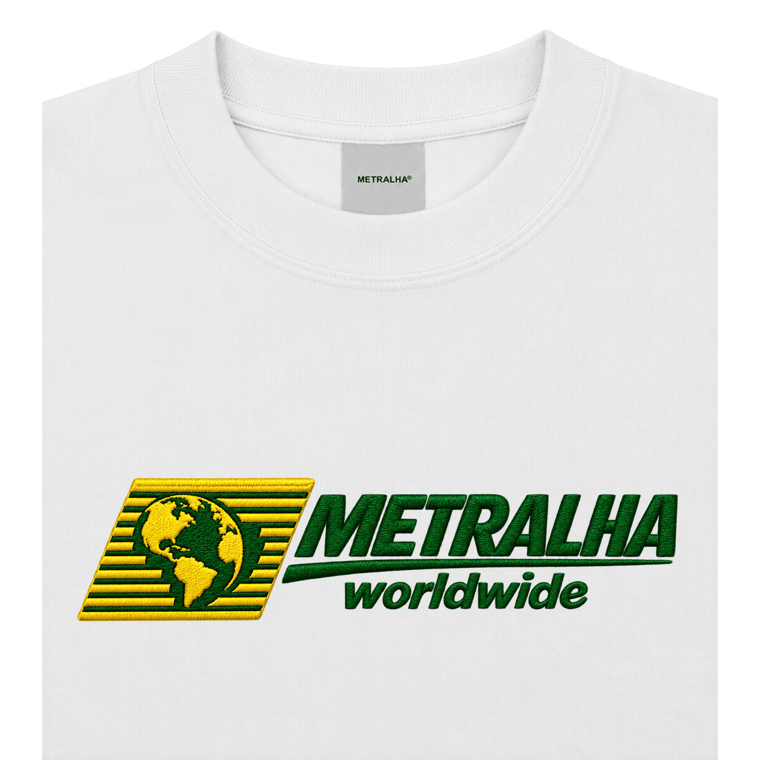 A white crewneck t-shirt featuring a green and yellow 'METRALHA worldwide' logo printed on the chest, with a visible 'METRALHA' brand tag inside the collar.