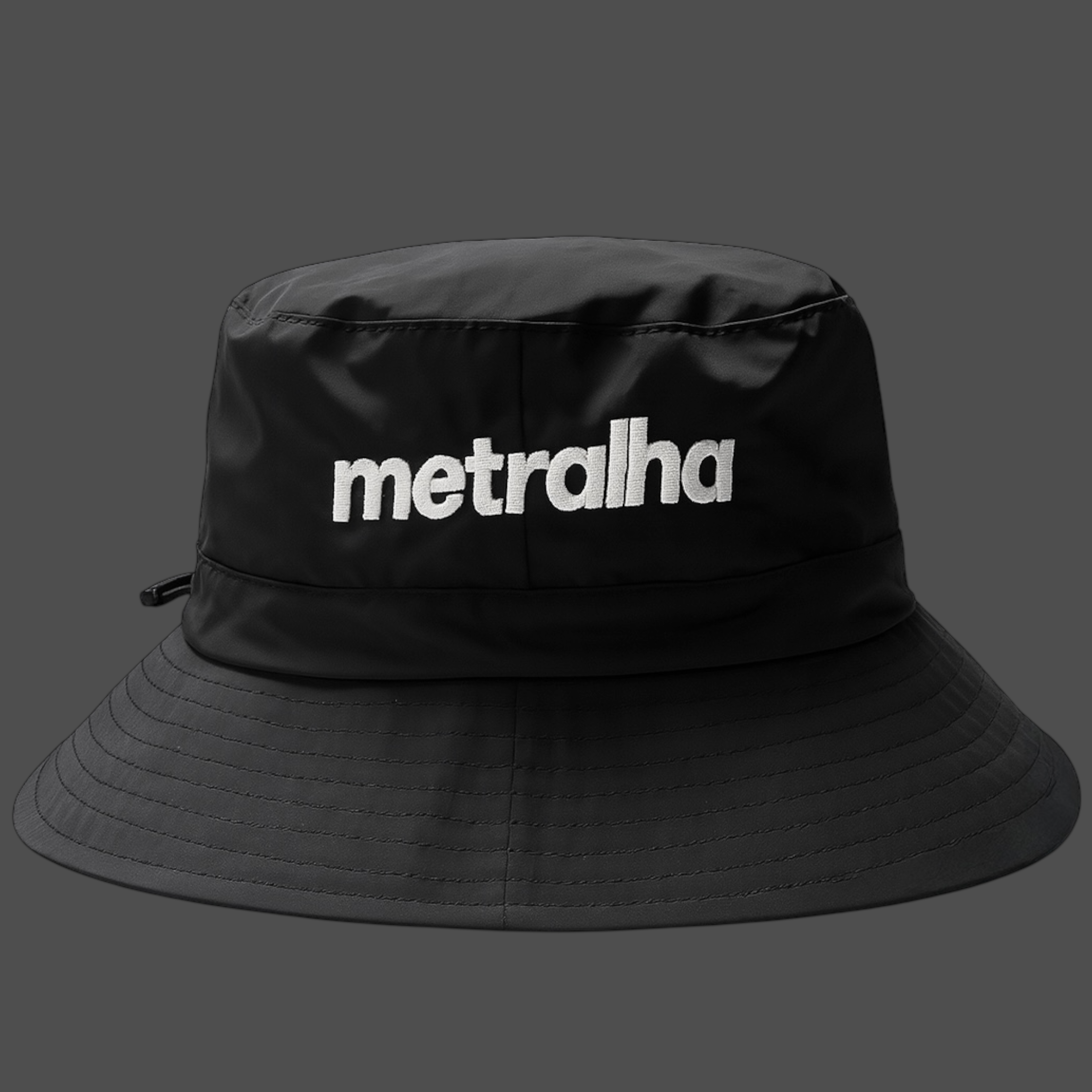 Black bucket hat with 'metralha' logo on a gray background
