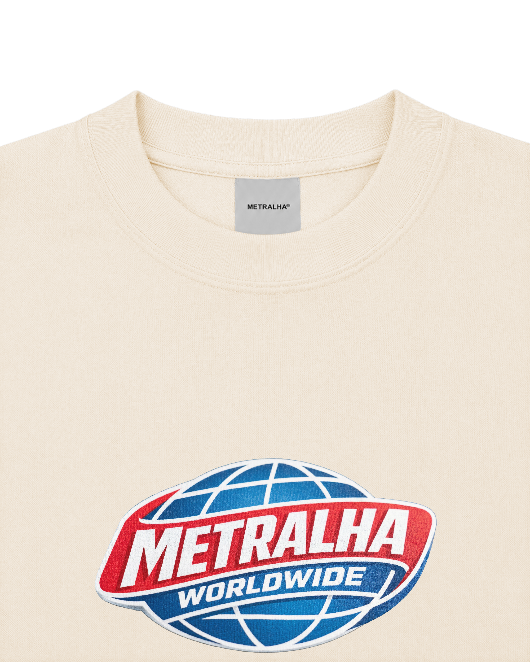 Close-up of a cream-colored crewneck t-shirt featuring a large red, white, and blue Metralha Worldwide globe logo printed on the chest.