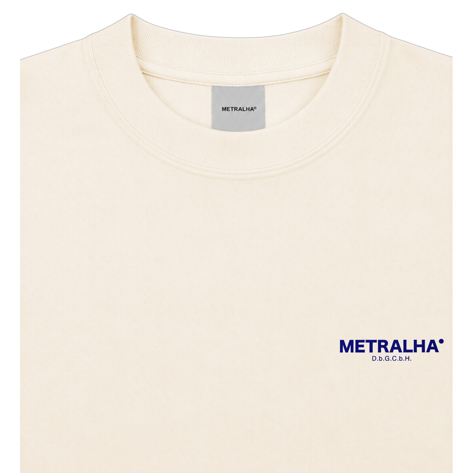 A close-up of a cream-colored crewneck t-shirt with the brand name 'METRALHA' printed in navy blue on the left chest, along with 'DS&GANG' underneath. The inner neck label also shows the brand name.